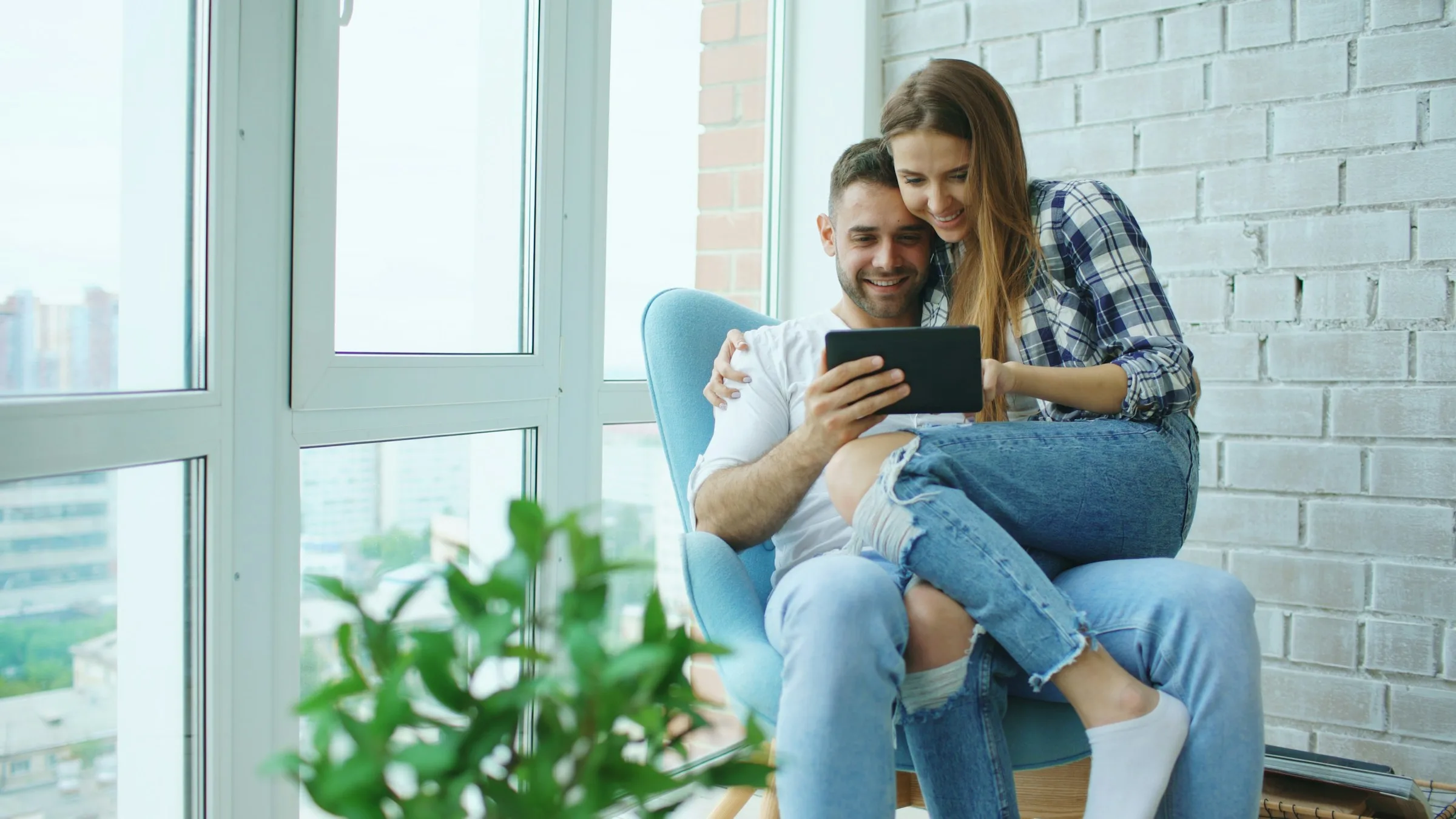 Home buyers reviewing a search on a tablet